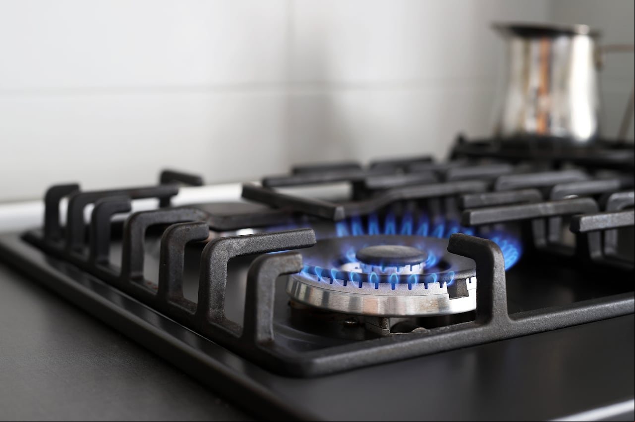 Close up of blue fire from the kitchen hob with propane gas. Stove. Gas crisis. Rising prices.
