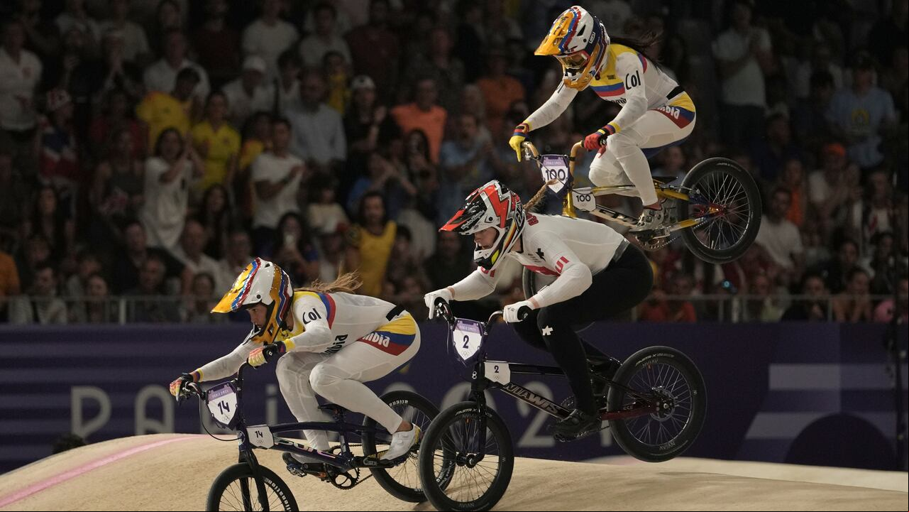 Gabriela Bolle Carrillo of Colombia, left, leads Zoe Claessens of Switzerland and Mariana Pajon Londono of Colombia during a women's BMX racing event, at the 2024 Summer Olympics, Thursday, Aug. 1, 2024, in Saint-Quentin-en-Yvelines, . (AP Photo/Thibault Camus)