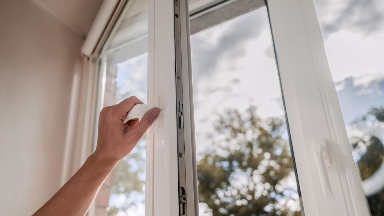 Persona abriendo ventana