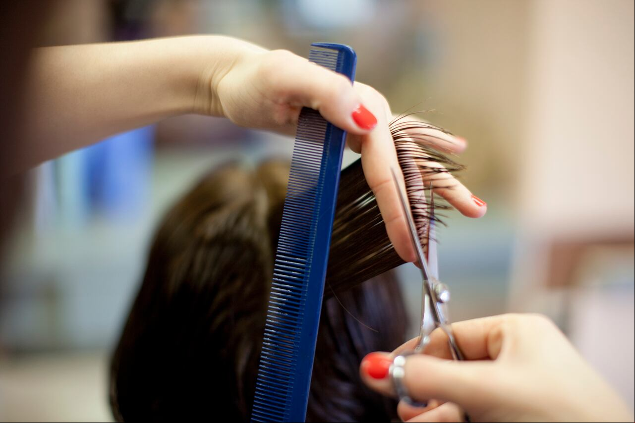 Woman 40s getting hair cut at hairdresser