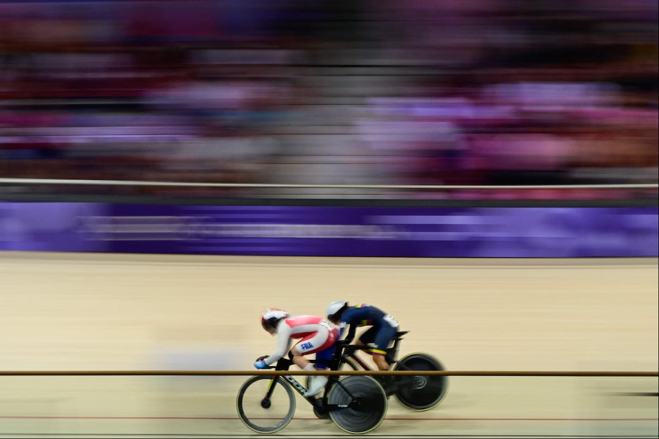 's Mathilde Gros and Colombia's Martha Bayona Pineda compete in the women's track cycling sprint 1/16 final of the Paris 2024 Olympic Games at the Saint-Quentin-en-Yvelines National Velodrome in Montigny-le-Bretonneux, south-west of Paris, on August 9, 2024. (Photo by John MACDOUGALL / AFP)