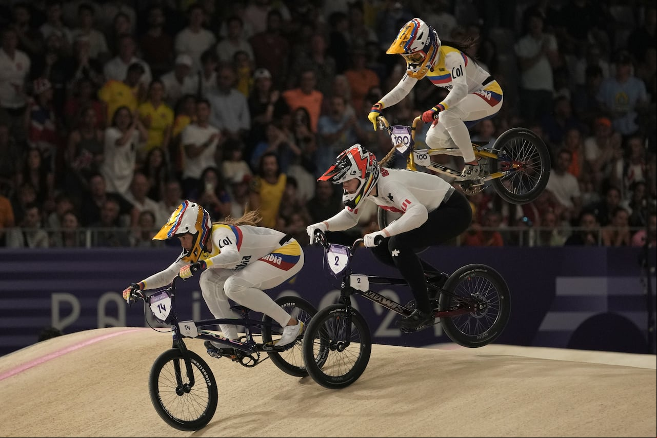 Gabriela Bolle Carrillo of Colombia, left, leads Zoe Claessens of Switzerland and Mariana Pajon Londono of Colombia during a women's BMX racing event, at the 2024 Summer Olympics, Thursday, Aug. 1, 2024, in Saint-Quentin-en-Yvelines, . (AP Photo/Thibault Camus)