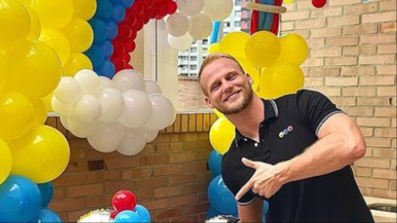 Comité paralímpico le ofrece la camiseta a Dominic Wolf para que la use.
