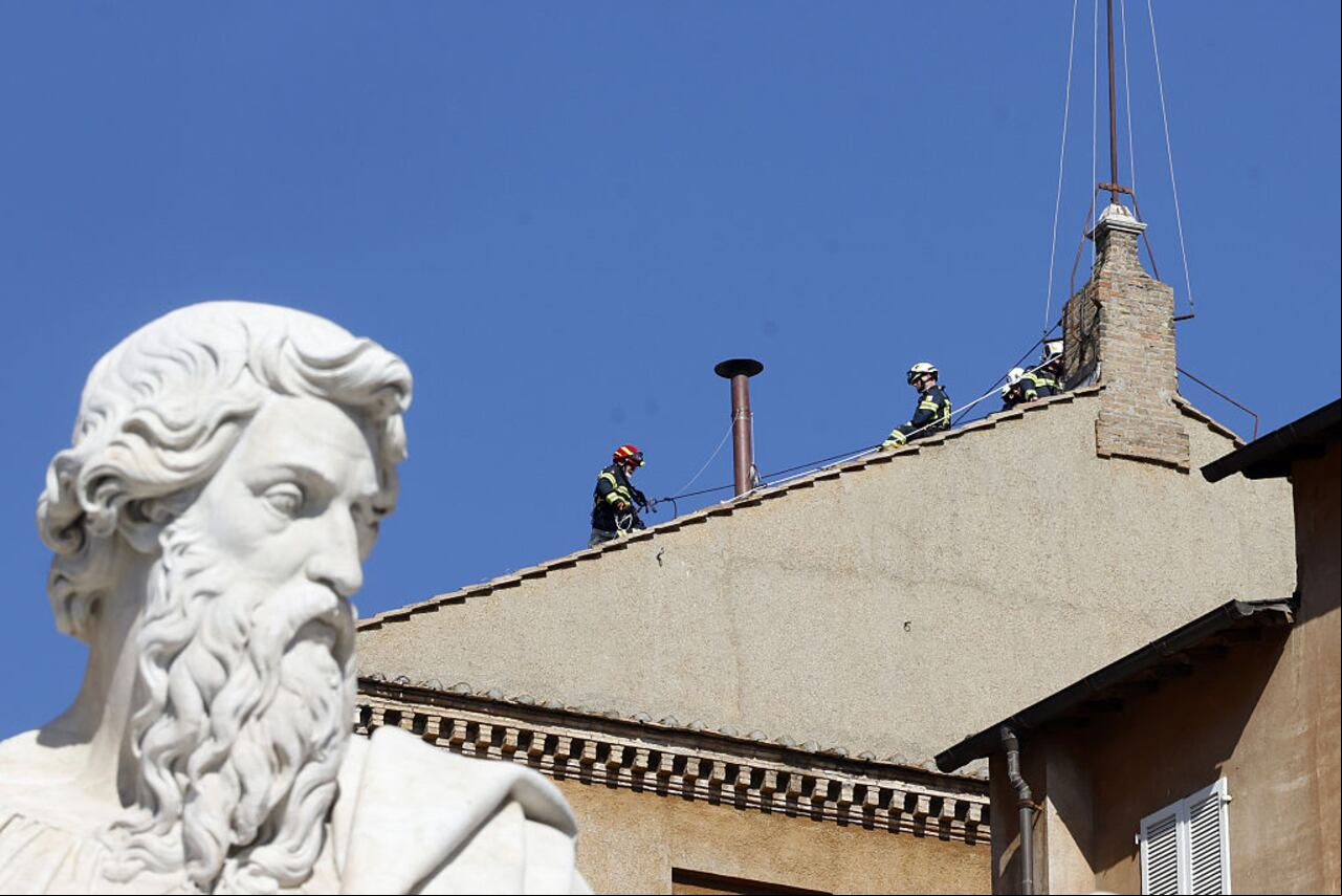 VATICAN CITY, VATICAN - MAY 2: Vatican firefighters set the chimney on the roof of the Sistine Chapel where, starting from May 7, cardinals will gather in the Conclave to elect the new pope, at the Vatican City, Vatican on May 2, 2025. Either white or black smoke will emerge from the chimney, depending on the outcome of the various rounds of voting held in the Sistine Chapel. (Photo by Riccardo De Luca/Anadolu via Getty Images)